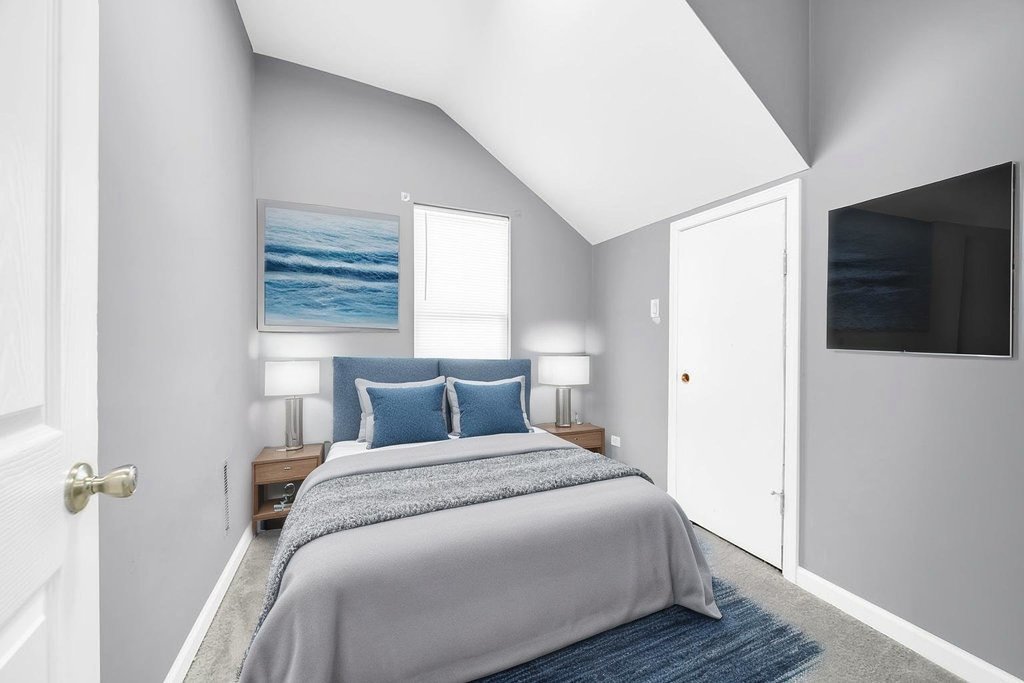 69 East 159th Street Harvey, IL 60426 - Photo 10 of 25 a bedroom with a bed and a flat screen tv