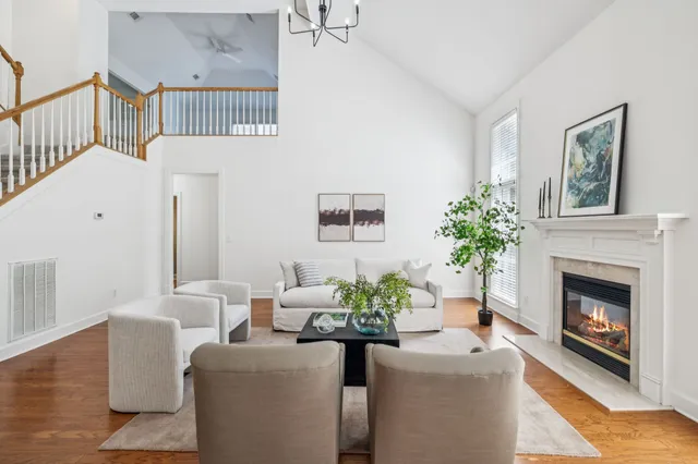 a dining room with furniture a chandelier and wooden floor
