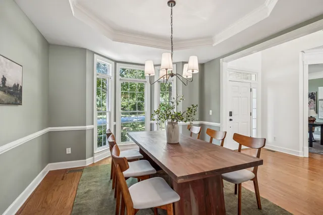 a kitchen with stainless steel appliances granite countertop a stove a refrigerator and a dining table