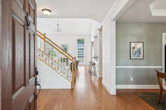 a living room with furniture and a chandelier
