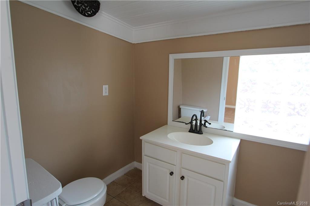 6616 Charlie Walker Road Kannapolis, NC 28081 - Photo 13 of 16 a bathroom with a sink a toilet and mirror