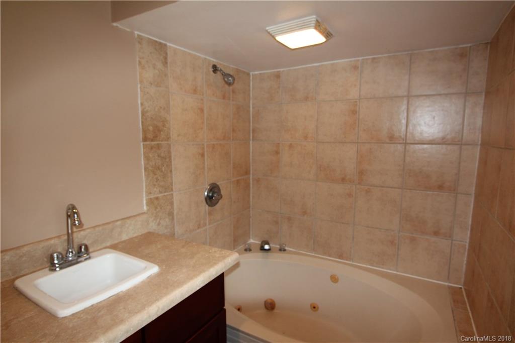 6616 Charlie Walker Road Kannapolis, NC 28081 - Photo 15 of 16 a bathroom with a sink a toilet and shower