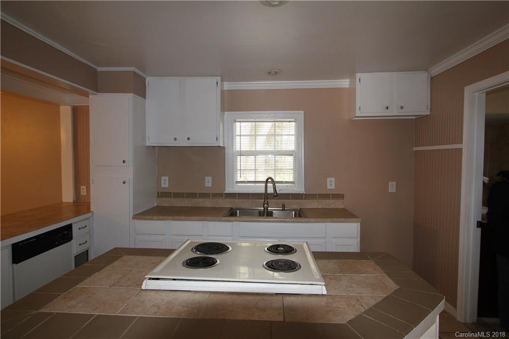 6616 Charlie Walker Road Kannapolis, NC 28081 - Photo 8 of 16 a view of kitchen island with sink stove and refrigerator