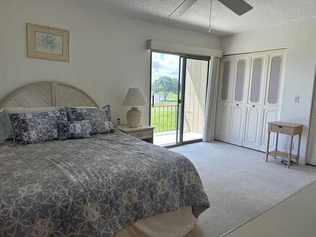 a large bed sitting in a bedroom next to a window