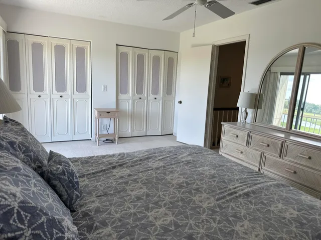 a spacious bedroom with a bed and a walk in closet