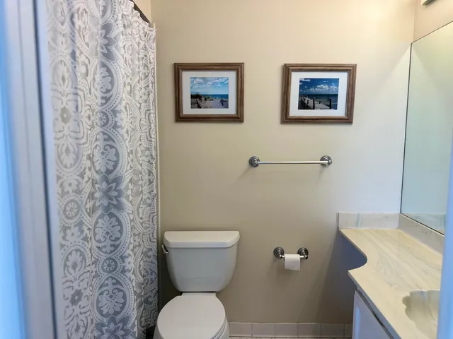 a white toilet sitting next to a bathroom sink