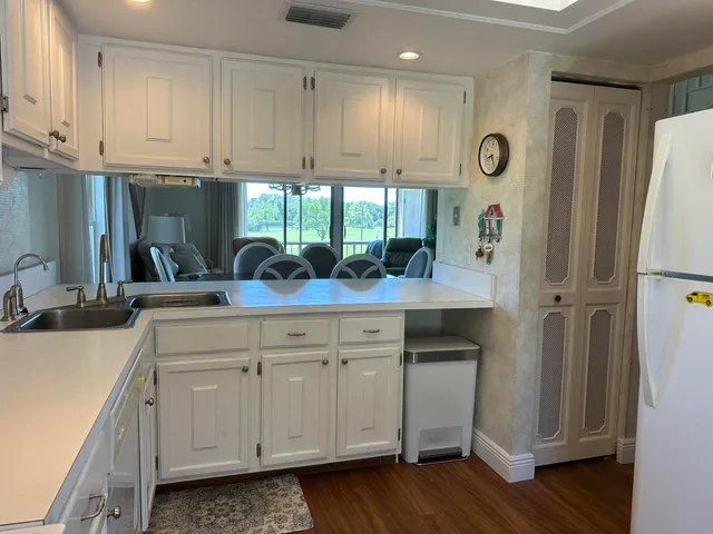 a kitchen with stainless steel appliances white cabinets and a window