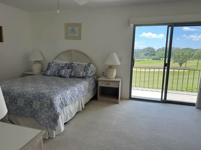 a spacious bedroom with a bed and a large window