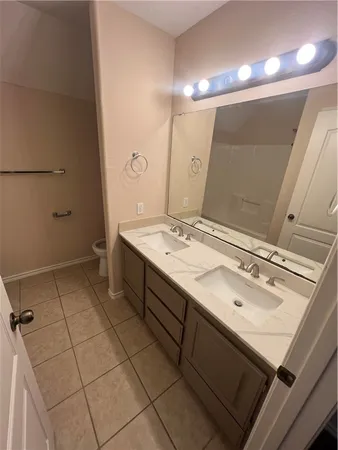 a bathroom with a sink a toilet and a mirror