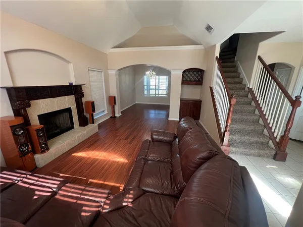 a living room with furniture and a fireplace