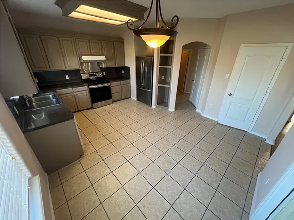 a kitchen with stainless steel appliances a refrigerator and a stove