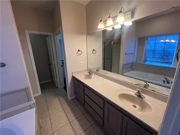 a bathroom with a double vanity sink and a mirror