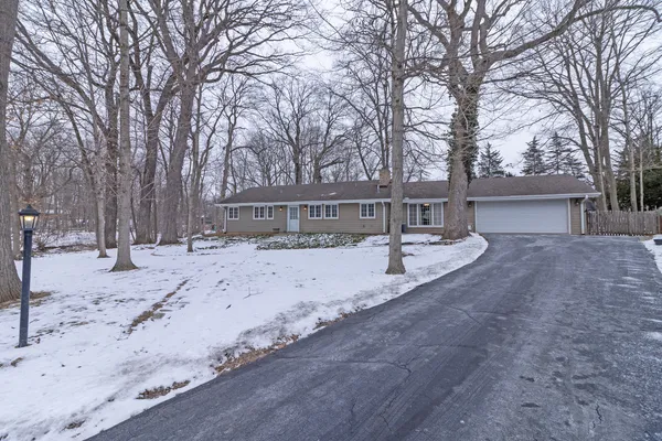 a view of a house with snow on the road