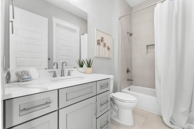 a bedroom with a bed couch and a window