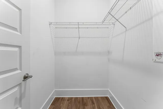 an aerial view of residential building and car parked side of road