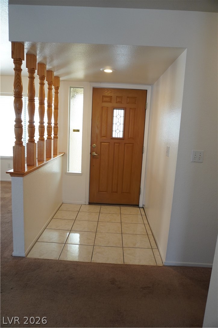 8328 Del Rey Avenue Las Vegas, NV 89117 - Photo 24 of 38 A welcoming entryway with natural wood door and elegant tile flooring.