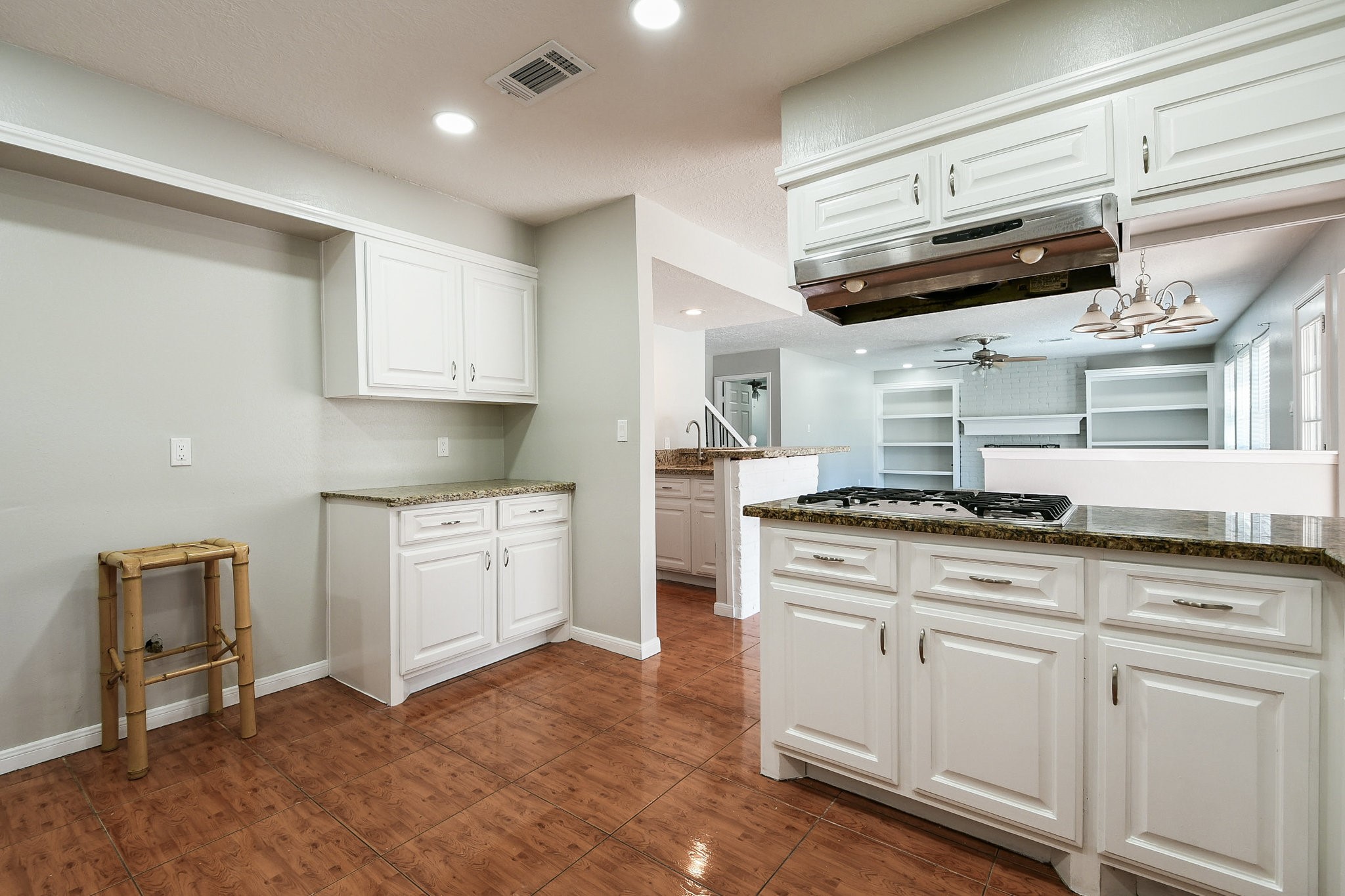 1007 Maranon Lane Houston, TX 77090 - Photo 14 of 36 a kitchen with stainless steel appliances granite countertop a stove and white cabinets