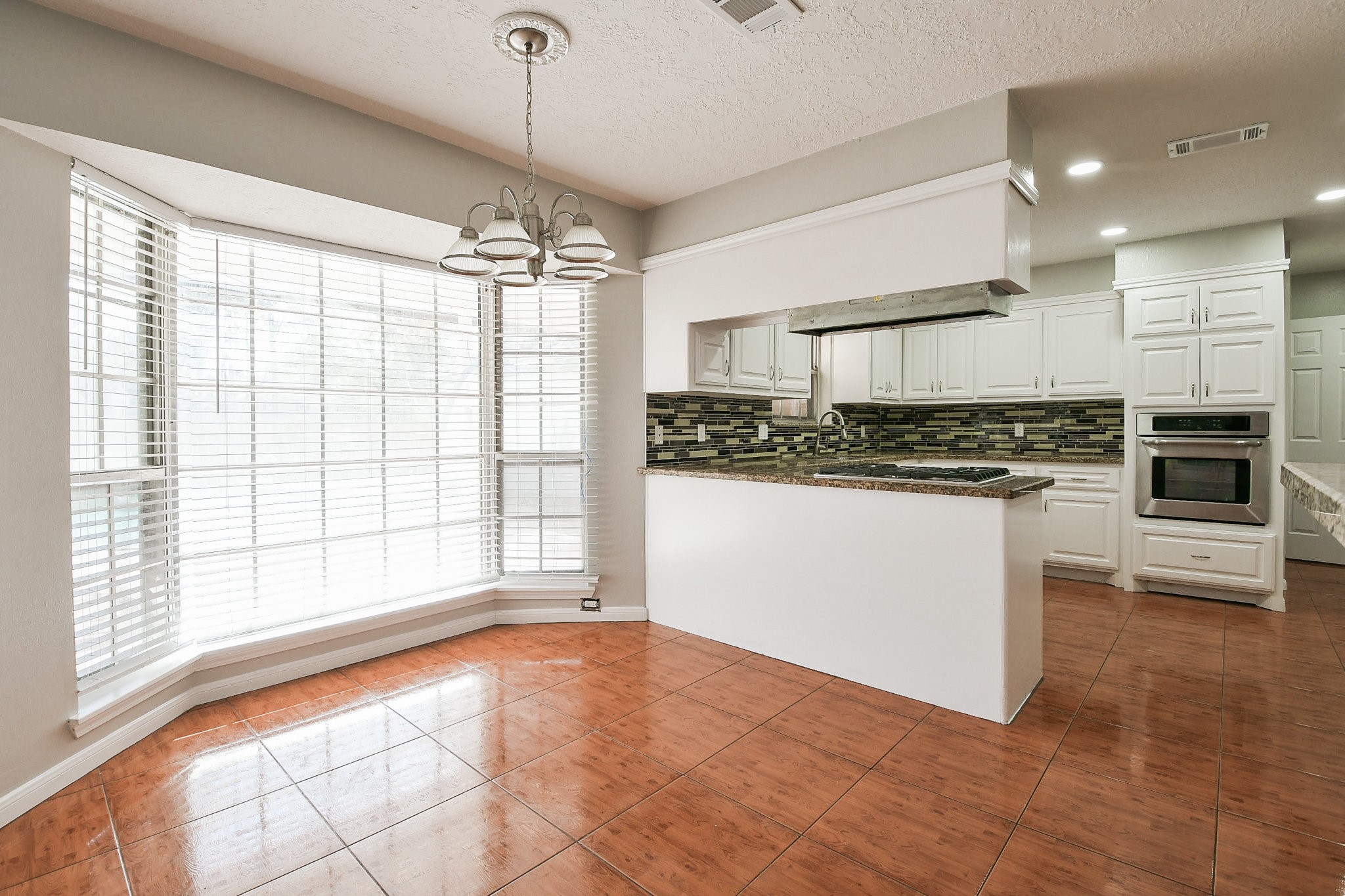 1007 Maranon Lane Houston, TX 77090 - Photo 16 of 36 a kitchen with stainless steel appliances granite countertop a stove a sink and a microwave