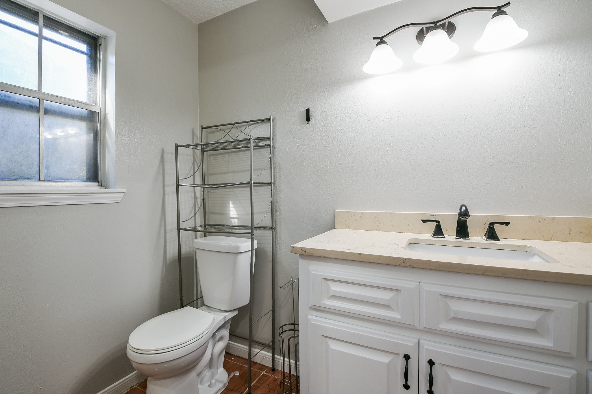 1007 Maranon Lane Houston, TX 77090 - Photo 20 of 36 a bathroom with a granite countertop toilet sink and mirror