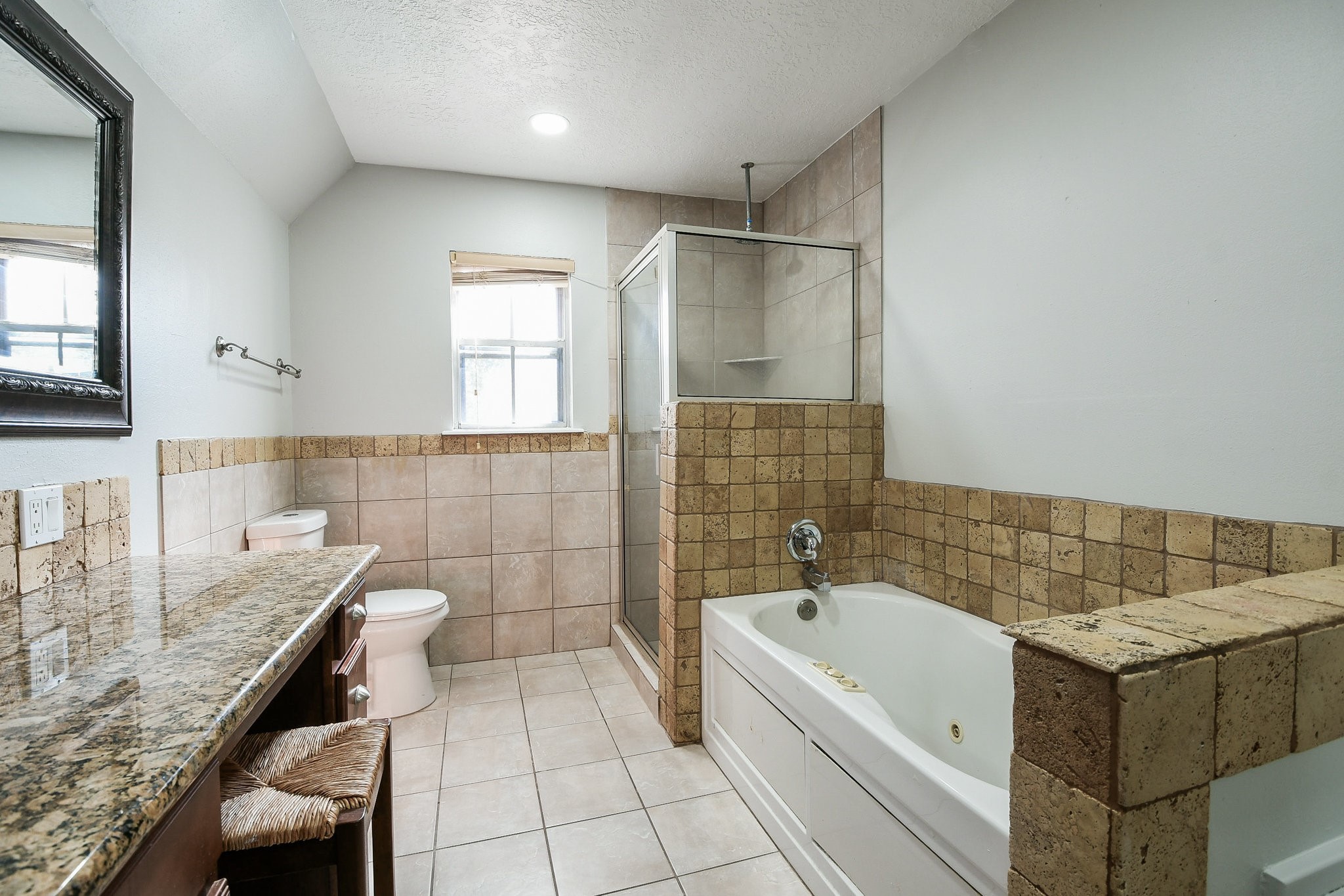 1007 Maranon Lane Houston, TX 77090 - Photo 24 of 36 a bathroom with a granite countertop sink a toilet and bathtub