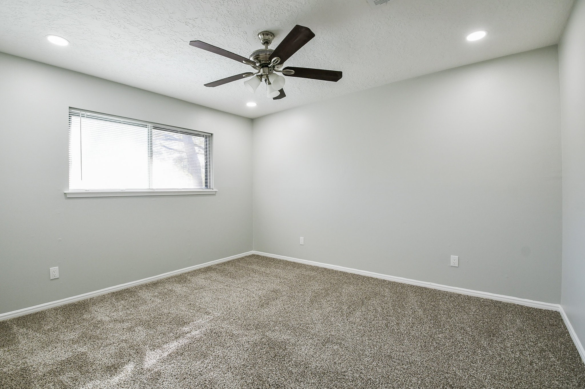 1007 Maranon Lane Houston, TX 77090 - Photo 27 of 36 an empty room with a window and a fan