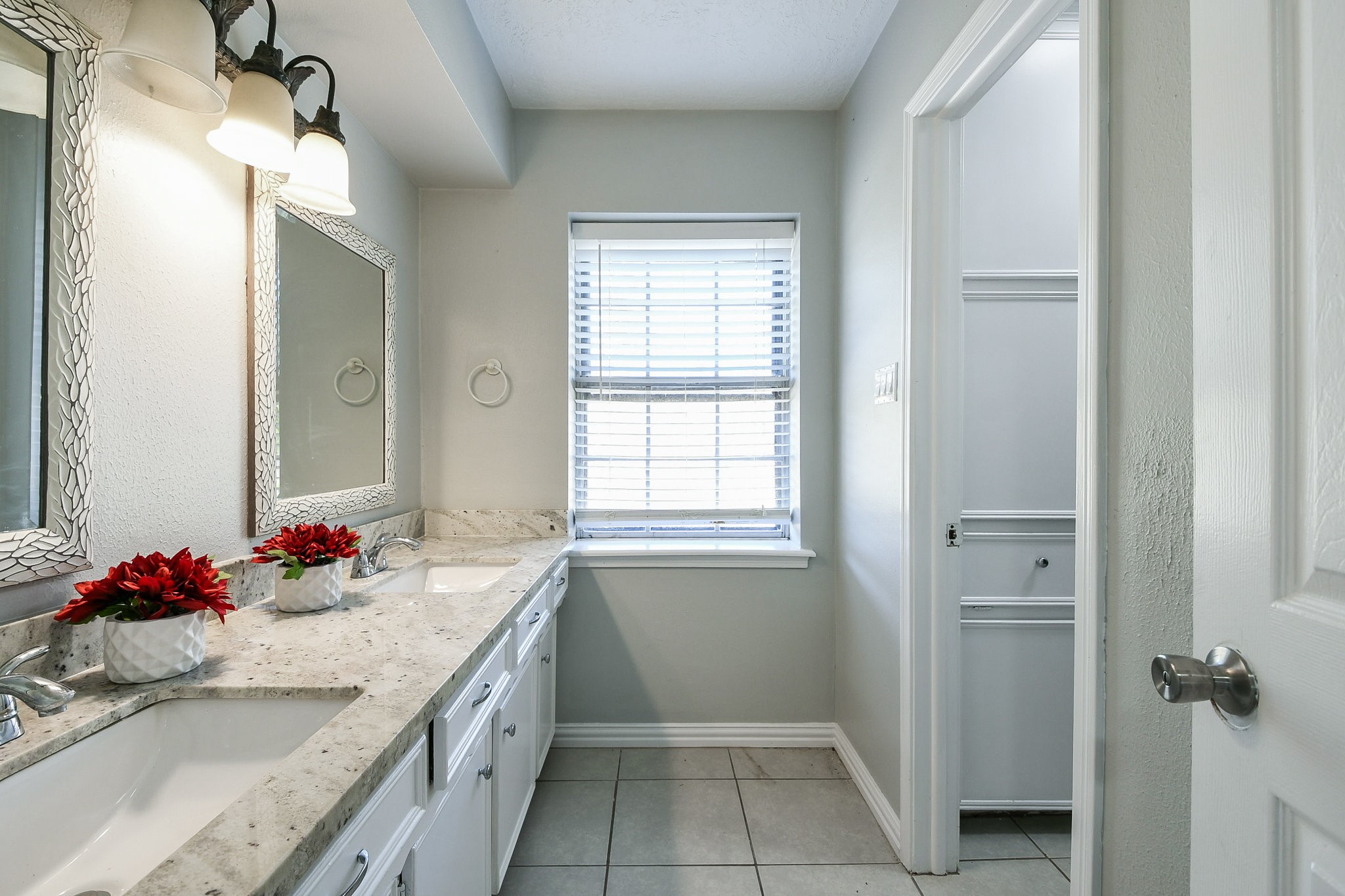 1007 Maranon Lane Houston, TX 77090 - Photo 29 of 36 a bathroom with a granite countertop sink a large mirror and a shower