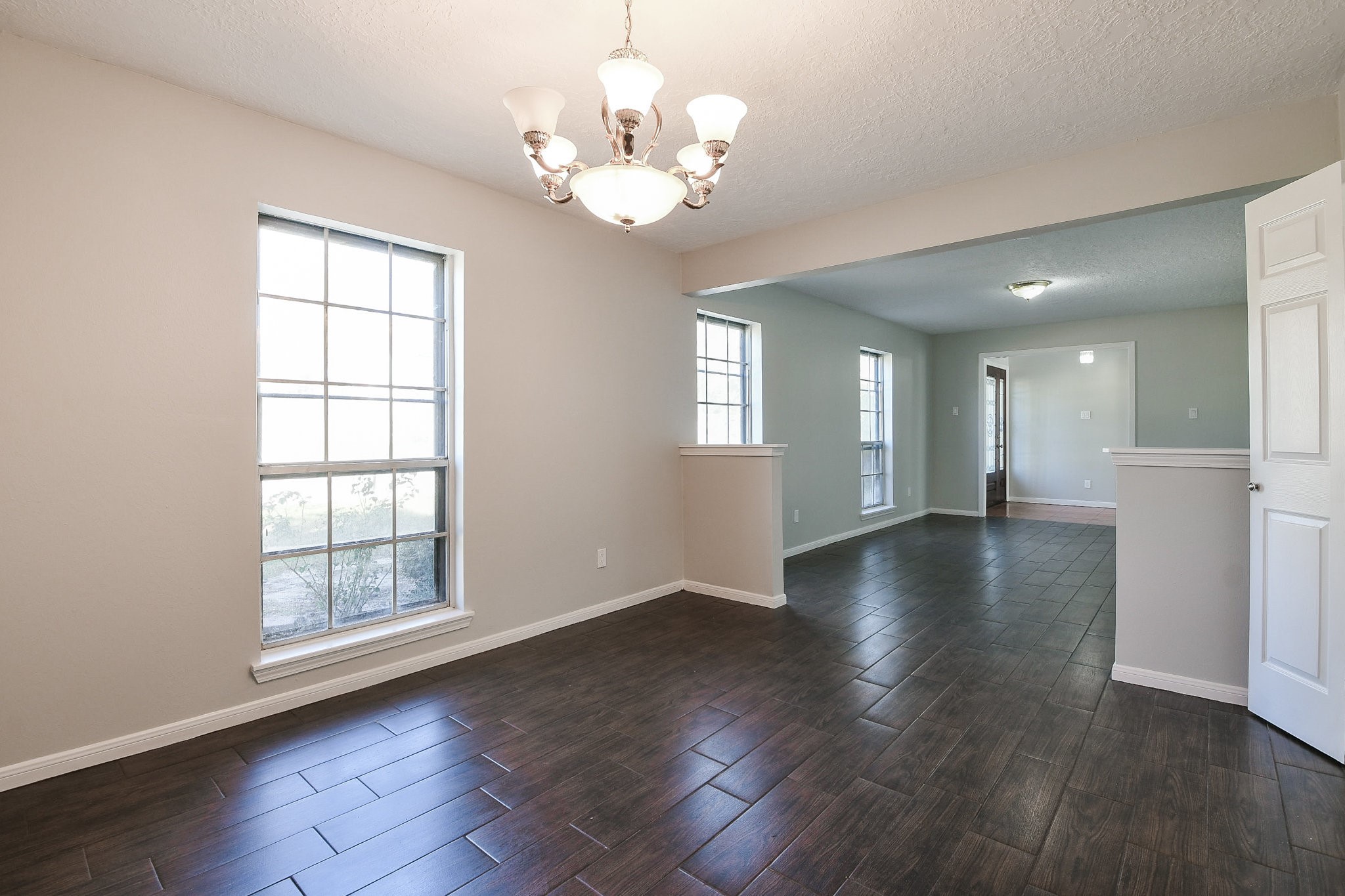 1007 Maranon Lane Houston, TX 77090 - Photo 7 of 36 a view of an empty room with wooden floor and a window