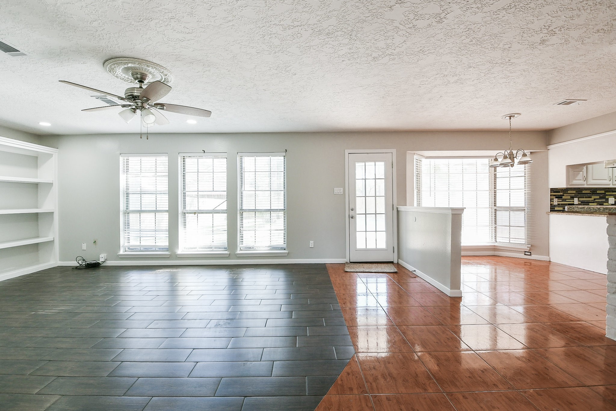 1007 Maranon Lane Houston, TX 77090 - Photo 10 of 36 a view of an empty room with a window and wooden floor