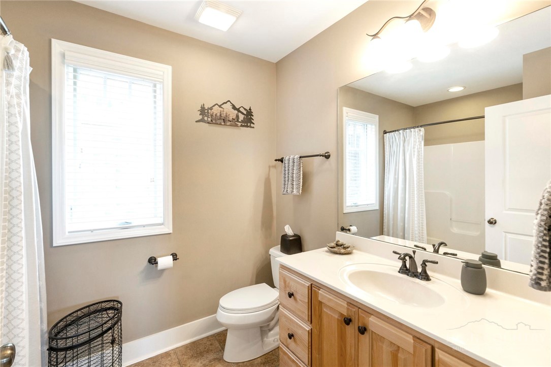 942 Ridge Haven Parkway, Unit R1211 Banner Elk, NC 28604 - Photo 25 of 45 a bathroom with a double vanity sink toilet and mirror