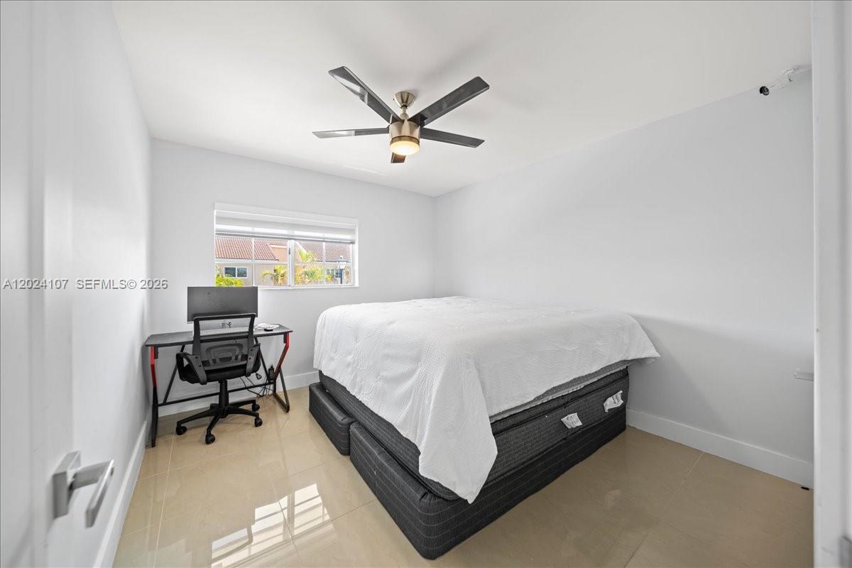 15341 Southwest 36th Street Miami, FL 33185 - Photo 25 of 56 a spacious bedroom with a bed and a chair