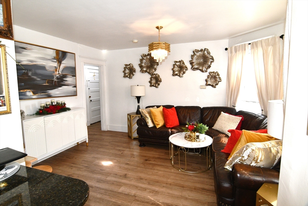 121 Cottage Street Everett, MA 02149 - Photo 11 of 35 a living room with furniture and a table
