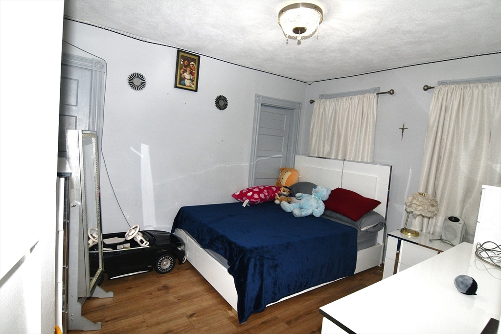 121 Cottage Street Everett, MA 02149 - Photo 13 of 35 a living room with furniture and a dresser
