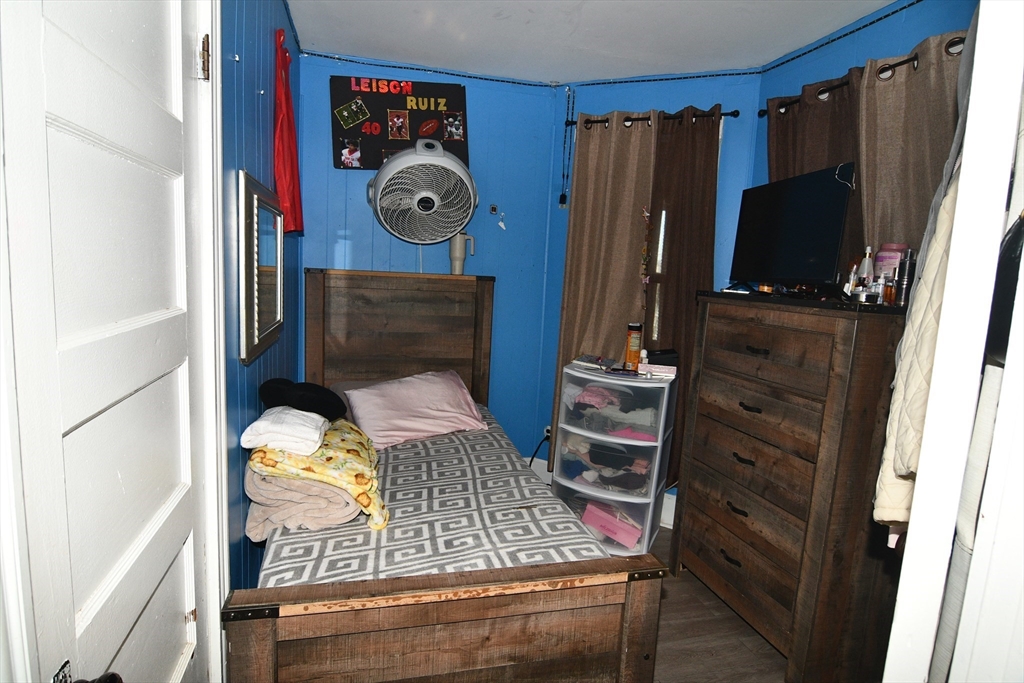 121 Cottage Street Everett, MA 02149 - Photo 15 of 35 a living room with chairs and a flat screen tv