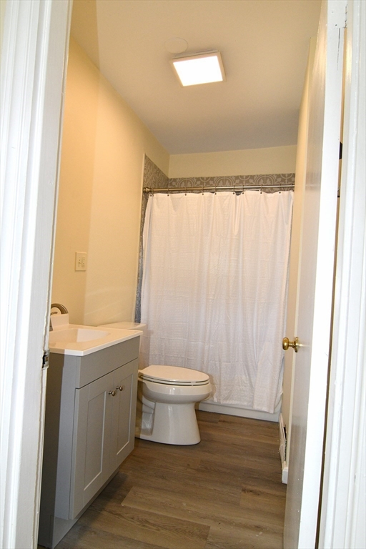 121 Cottage Street Everett, MA 02149 - Photo 22 of 35 a bathroom with a sink a toilet a window and shower