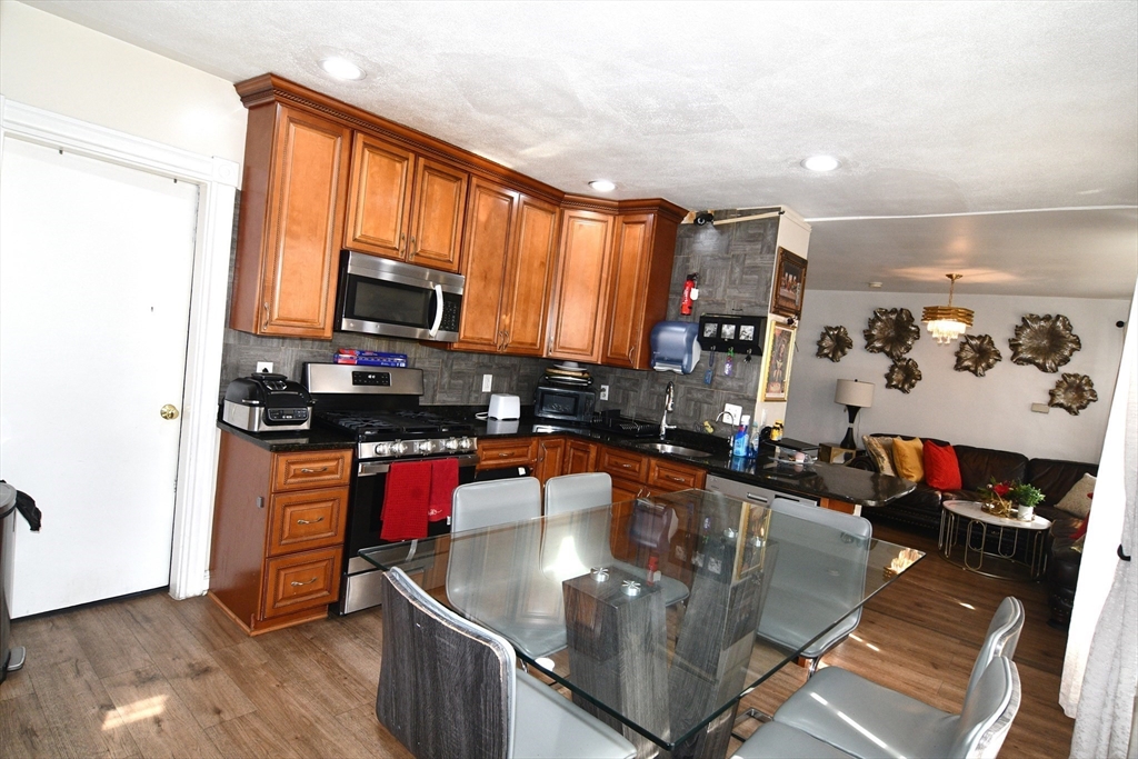 121 Cottage Street Everett, MA 02149 - Photo 9 of 35 a kitchen with a stove a sink and a microwave