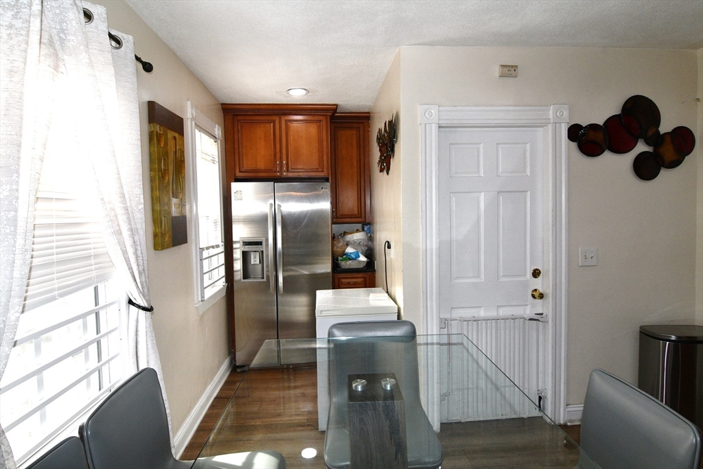 121 Cottage Street Everett, MA 02149 - Photo 10 of 35 a kitchen with a refrigerator and a stove
