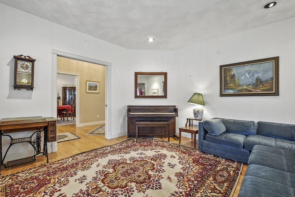 64 Leslie Road Rowley, MA 01969 - Photo 4 of 36 a living room with furniture and a wooden floor