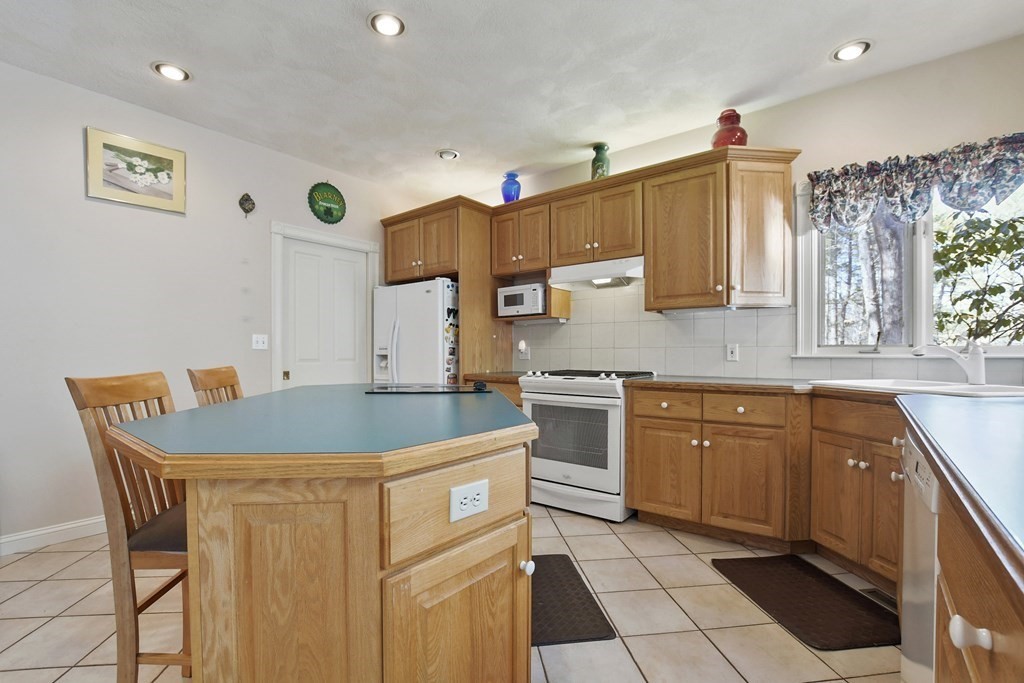 64 Leslie Road Rowley, MA 01969 - Photo 9 of 36 a kitchen with a sink and cabinets