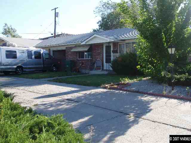 1510 West 7th Street Reno, NV 89503 - Photo 1 of 2 a front view of a house with a garden and trees
