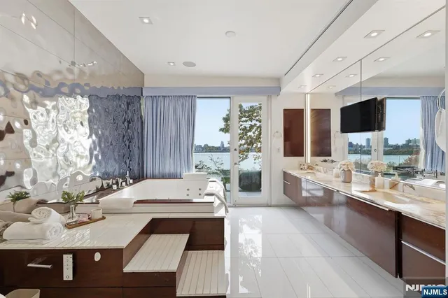 a large bathroom with a large tub sink and shower