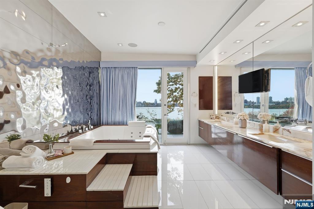 31 A Casta Lane Edgewater, NJ 07020 - Photo 11 of 21 a large bathroom with a large tub sink and shower