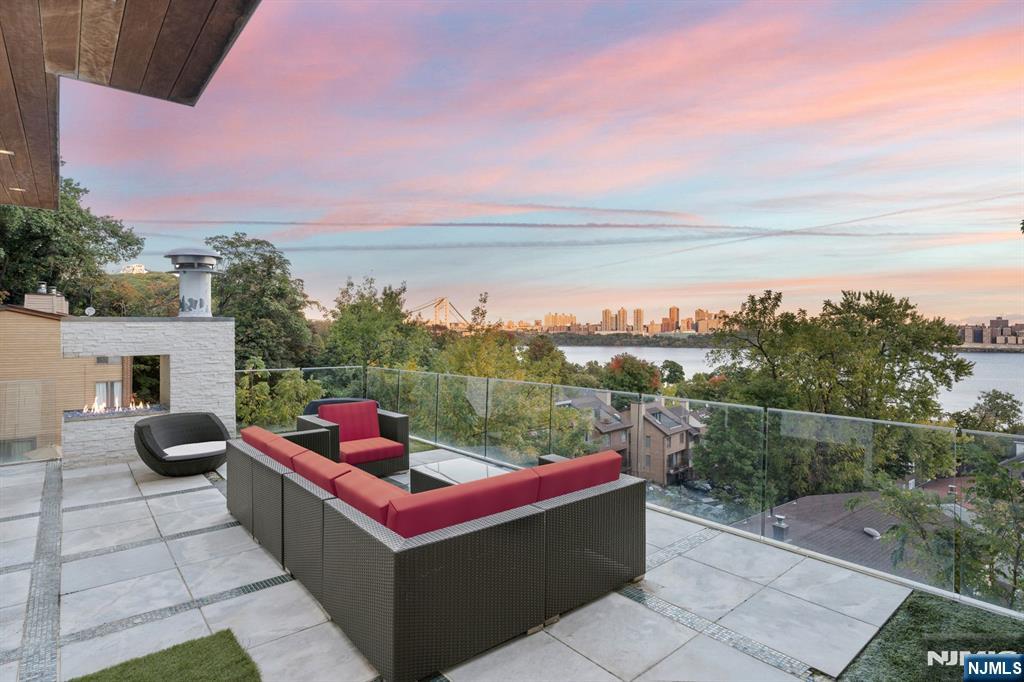 31 A Casta Lane Edgewater, NJ 07020 - Photo 21 of 21 a view of a terrace with couches and sky view