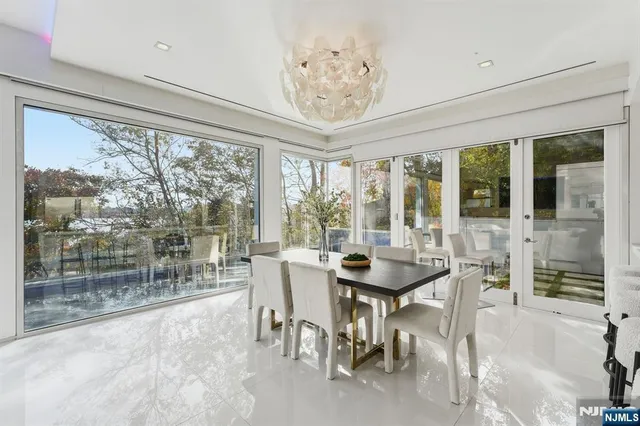 a view of a dining room with furniture large windows and wooden floor