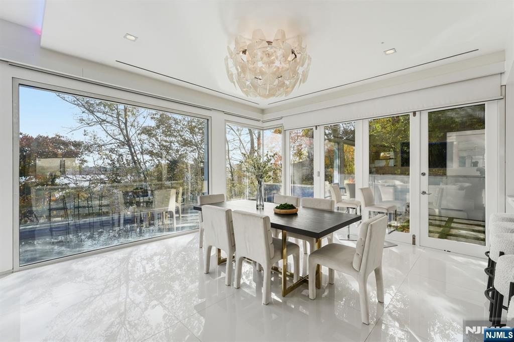 31 A Casta Lane Edgewater, NJ 07020 - Photo 7 of 21 a view of a dining room with furniture large windows and wooden floor
