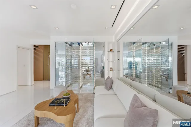 a living room with furniture and a floor to ceiling window