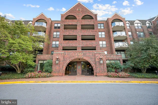 a front view of a residential apartment building with a yard