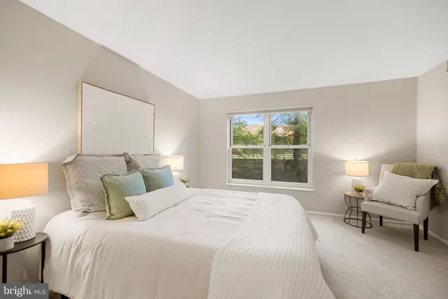 a bedroom with a large bed and a large window