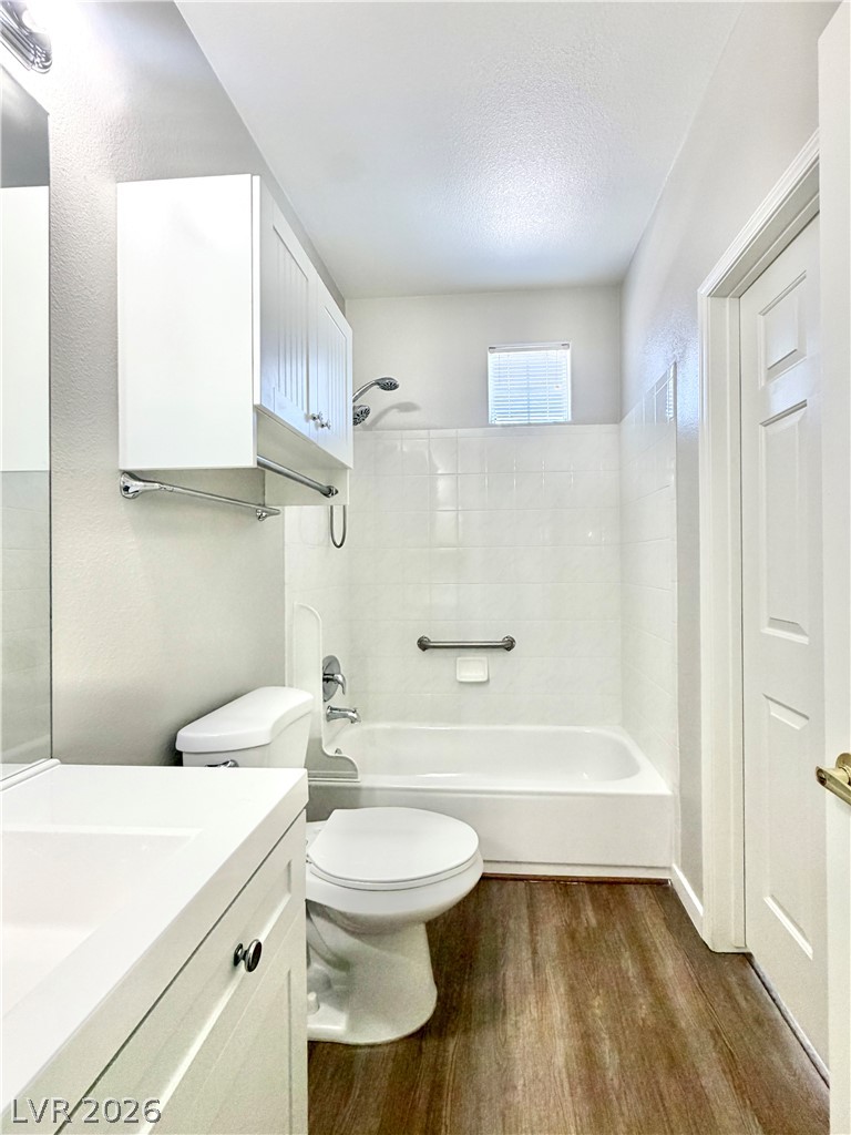 8555 West Russell Road, Unit 2018 Las Vegas, NV 89113 - Photo 18 of 23 Functional full bathroom featuring a tub-shower combination, modern vanity, and practical wood-look flooring.