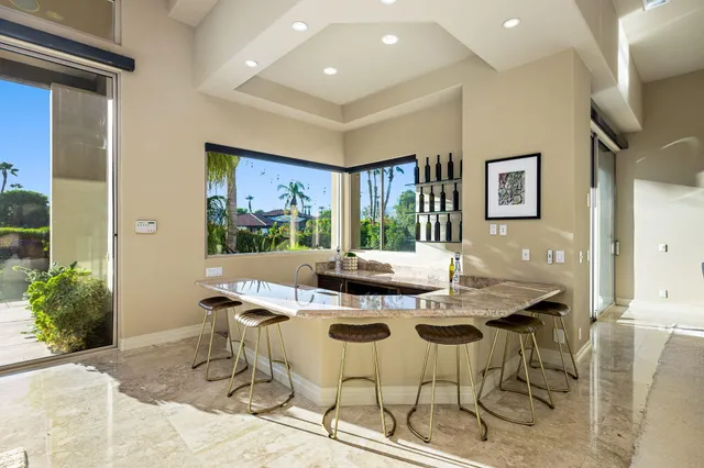 a dining room with furniture and a chandelier