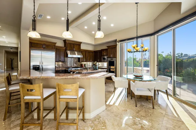 a kitchen with stainless steel appliances granite countertop a stove and a sink